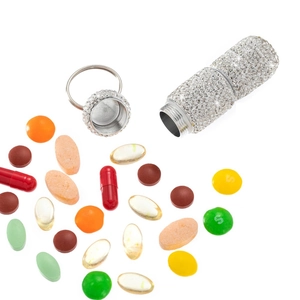 Mini rhinestone pill box keychain with a waterproof metal seal shown with loose pills