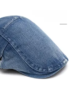 Detail of blue denim ivy cap featuring a wide bendable brim and contrast stitching