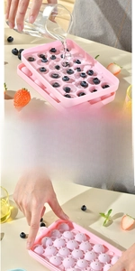 Pink silicone sphere ice tray detail showing step-by-step water filling and lid closure