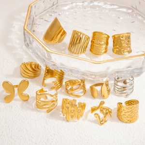 Detailed view of assorted 18k gold and silver stainless steel rings on a jewelry tray