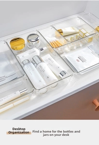 Detailed top view of clear acrylic drawer organizers for cosmetics and small accessories