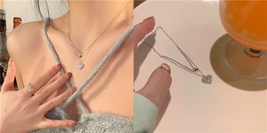 Close-up of double-layer silver heart necklace and butterfly ring on model
