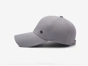 Side profile of grey baseball cap featuring breathable mesh texture and metal logo detail