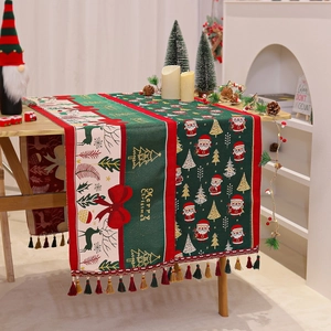 Detail of Christmas table runner featuring Santa Claus prints and colorful edge tassels