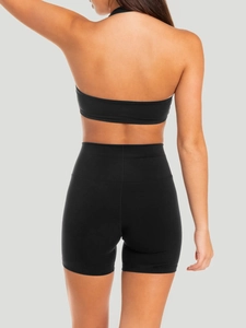 Rear view of black athletic two-piece set featuring halter crop top and high-waisted shorts