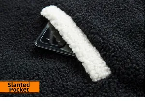 Close-up of side pocket on black fleece jacket with white contrast trim and phone inside