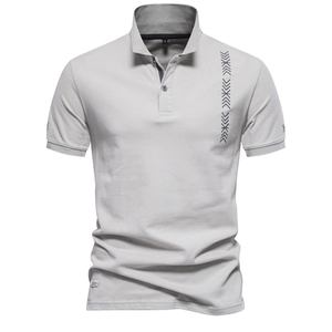Close-up of grey polo shirt featuring pique cotton texture and vertical geometric print