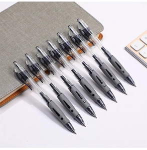 Detailed shot of retractable gel pens with soft grips on a desk next to a keyboard