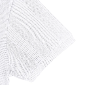 Close-up of white jacquard polo shirt sleeve showing breathable mesh knit texture