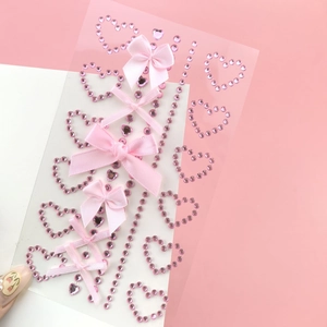 DIY decorative stickers with pink rhinestone hearts and ribbon bows on clear background