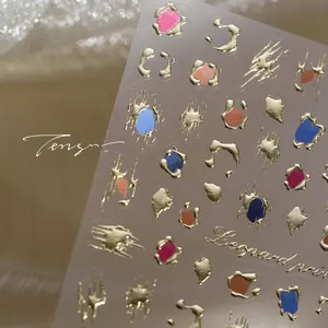 Close-up of leopard print nail art stickers with gold embossed edges and vibrant colors