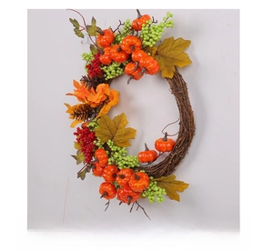 Side view of autumn wreath with pumpkins, maple leaves, and berries on vine base