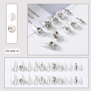 Detail of 24pcs silver glitter press-on nails with rhinestones and pearl flower accents