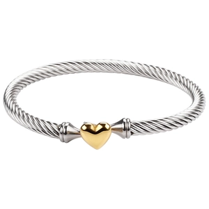 Silver-toned cable twist bracelet featuring a polished gold-plated heart-shaped charm