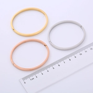 Polished minimalist titanium steel bangles in gold, silver, and rose gold finishes