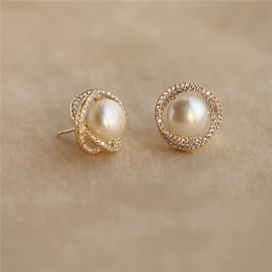 Elegant gold plated silver pearl earrings with crisscross crystal paved rings