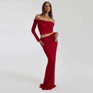 Detail of red off-shoulder long sleeve top and maxi skirt set with draped fabric texture