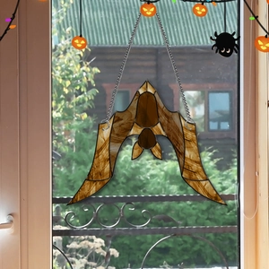 Detail of bat-shaped acrylic suncatcher with wood grain texture and metal chain