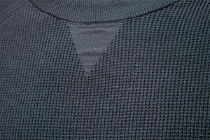 Detail of dark grey knit sweater collar showing high-quality ribbed texture and stitching