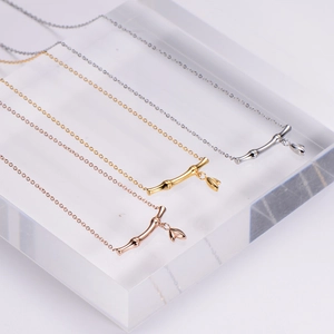 Minimalist bamboo pendant necklace in gold, silver, and rose gold with leaf charm