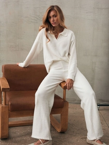 Women's white knitted two-piece set featuring a polo collar sweater and wide-leg trousers