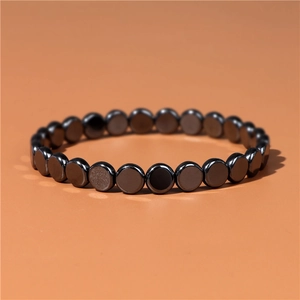 Retro black hematite stone disc bead stretch bracelet on orange background