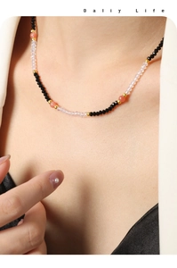 Detail of handcrafted beaded necklace with multifaceted natural stones and gold spacers