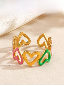 Detailed macro view of colorful enamel heart patterns on a gold-plated stainless steel ring