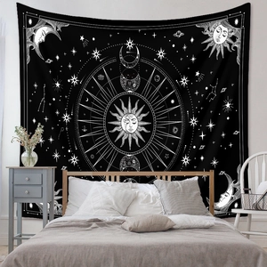 Detail of bohemian sun and moon phases tapestry hung as a headboard in a bedroom