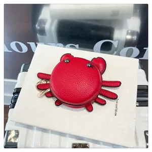 Detail of red crab leather coin purse showing premium lychee grain and gold metal clasp