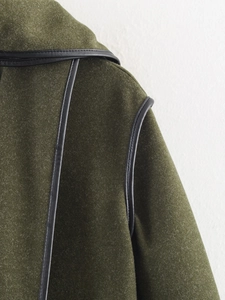 Detail of army green wool coat featuring black PU leather piping on collar and shoulder