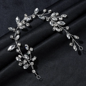 Silver bridal hair vine with marquise rhinestones on elegant black fabric background