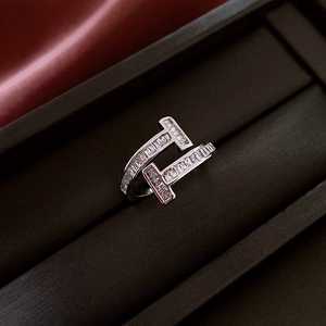 Macro detail of silver ring featuring sparkling baguette zircons in a T-shaped design