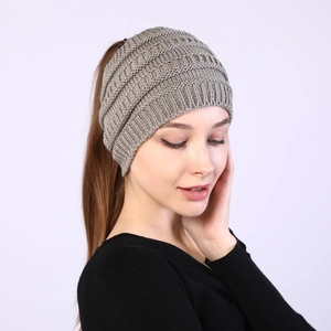 Detail of grey cable knit ponytail headband showing texture and top opening design