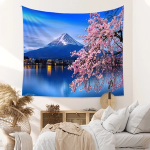 Detail view of Bohemian Mount Fuji tapestry with cherry blossoms in a cozy bedroom setup