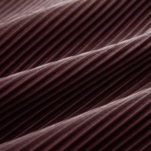 Macro texture of pleated dark burgundy fabric with a subtle leather-like glossy finish