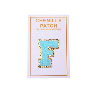 Close-up of a light blue chenille letter F patch with gold glitter borders and self-adhesive backing