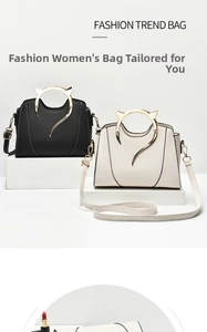 Detail of chic handbags in black and beige with unique cat-ear shaped golden handles