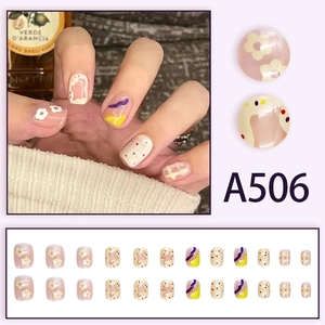 Short round press-on nails with colorful floral patterns and pastel polka dots