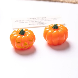 Detailed view of resin Halloween mini pumpkins with glowing Jack-O-Lantern smiling face