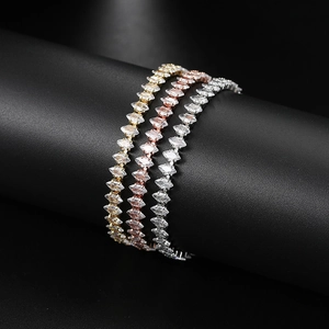 Detailed close-up of three tennis bracelets in gold, rose gold and silver with marquise zircons