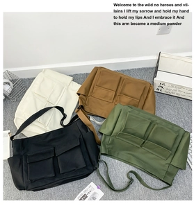 Flat lay of canvas messenger bags in cream, brown, black, and olive with front pockets