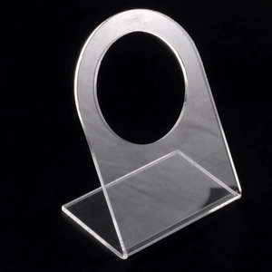 Clear acrylic display stand with circular cutout for jewelry and piercing model presentation