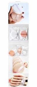 Macro shot of 9cm large makeup powder puffs in white and beige with satin finger straps