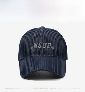 Close-up of a navy mesh baseball cap featuring grey NSDC embroidery and long visor