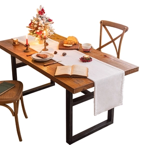 White plush table runner on a wooden dining table for winter Christmas home decor