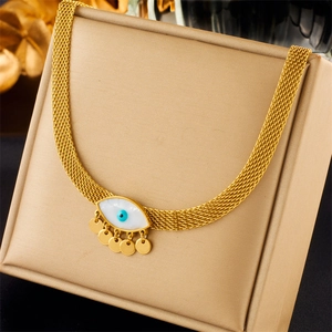 Close-up of golden mesh necklace with mother-of-pearl evil eye pendant and blue gem detail