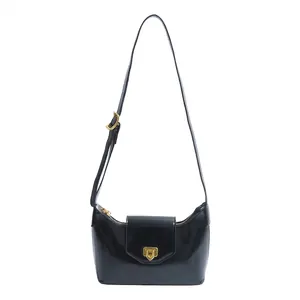 Elegant black glossy shoulder bag with gold square buckle and adjustable strap