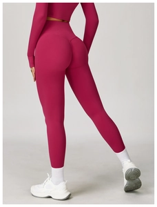 Detailed back view of high-waisted lifting yoga leggings in matte dark pink fabric