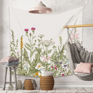 Detail of bohemian tapestry featuring vintage wildflower illustrations in a cozy room decor